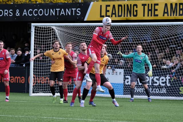 Boro striker Jake Charles puts in some defensive work by heading the ball clear during the loss to Southport PHOTOS BY RICHARD PONTER
