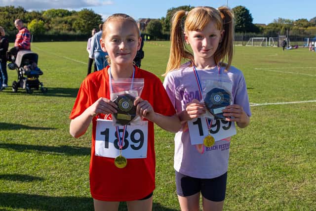 Harper Thompson and Marnie Wilkinson, both of Ruswarp School, show off their medals for finishing 1st and 2nd in the Year 4 Girls Race. Photo by Amelia Dyson of Elana Belle Photography