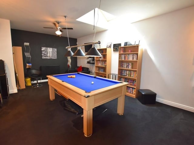 There is a spacious games room attached to the kitchen with plenty of room for a full-sized pool table