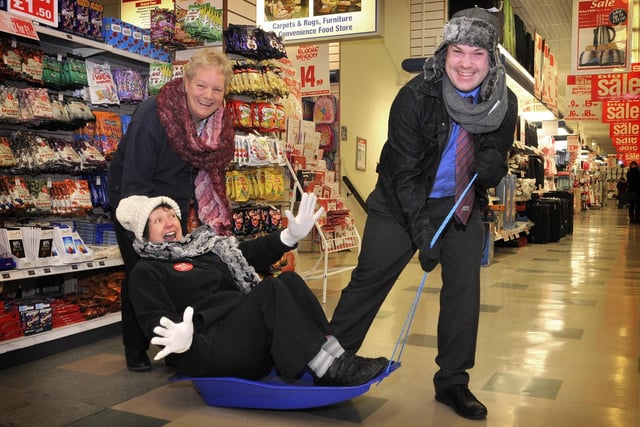 Staff have fun with the winter items on sale at Boyes in 2012.