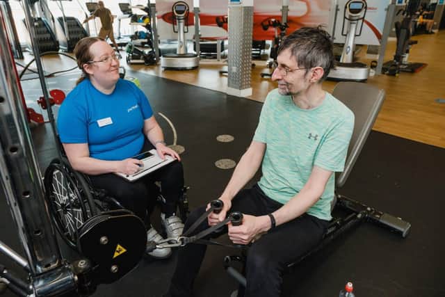 An instructor looking after a customer in the gym