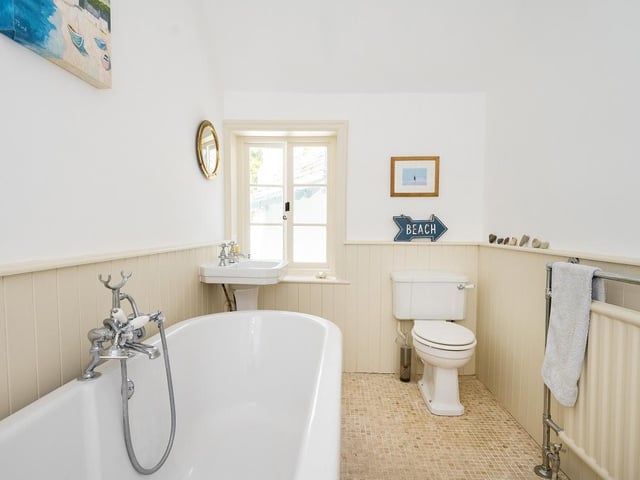 The house also has two house bathrooms, one with a bath and shower and an additional bathroom.