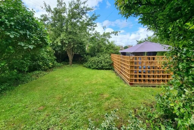 Along with this established and enclosed lawned garden are seating and hot tub areas.