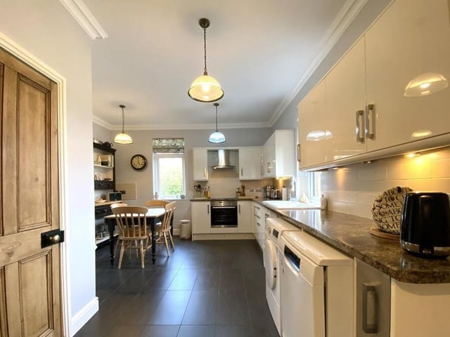 A spacious and modern kitchen with diner.