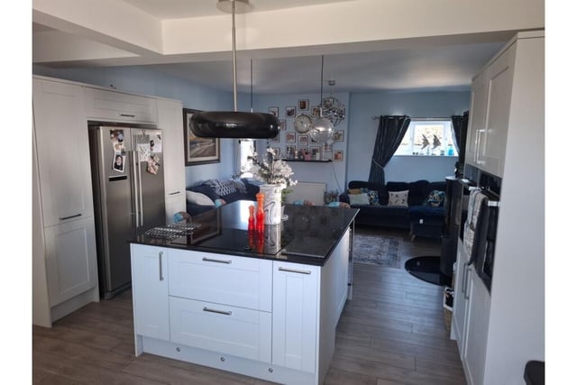 An open plan living kitchen with central island.