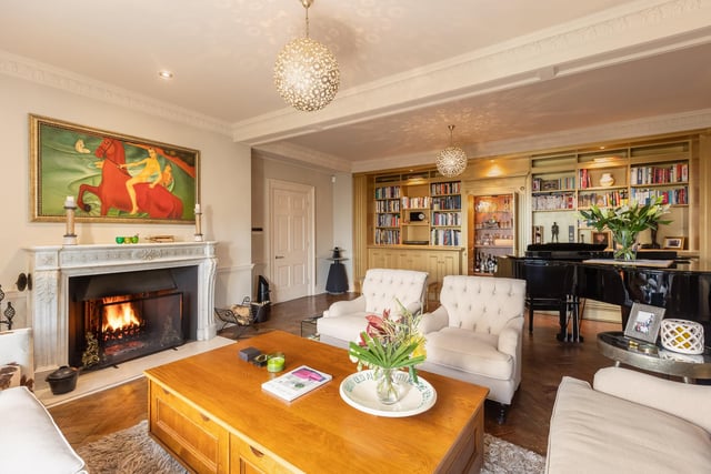 The drawing room, with restored parquet flooring, has a stunning fireplace.