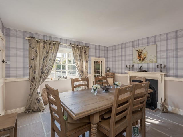 A light and spacious dining room with focal fireplace.