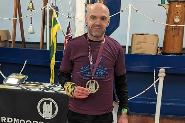 BRR athlete Danny Brunton shows off his medal after the Hardmoors 80 Mile.