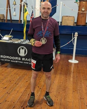 BRR athlete Danny Brunton shows off his medal after the Hardmoors 80 Mile.