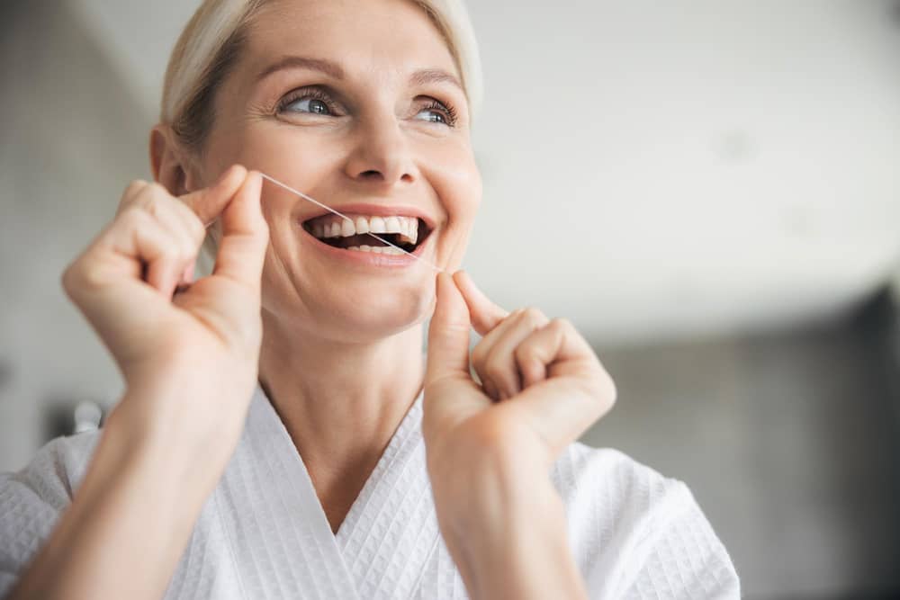 Research suggests that flossing your teeth at least once a week can markedly reduce the risk not only of having a stroke, but also reduce the risk of developing atrial fibrillation. Photo: StockAdobe