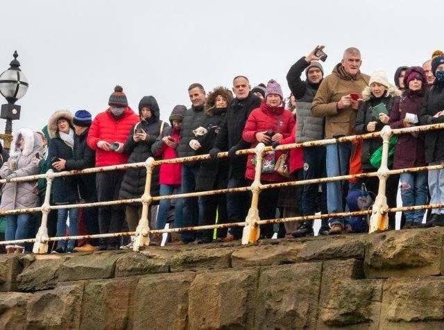 A good crowd enjoys the 2021 Boxing Day dip in Whitby.