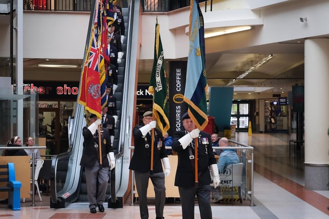 The standard bearers make their way from the escalator