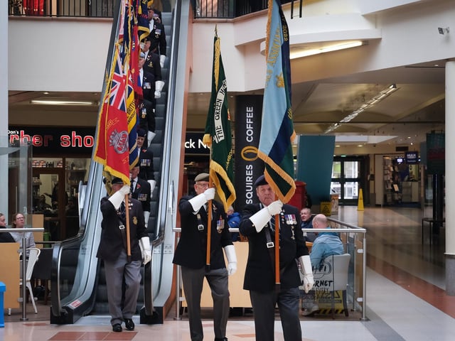 The standard bearers make their way from the escalator