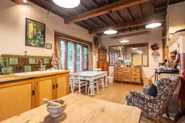 The beamed dining kitchen has sea views, and enjoys warmth from a newly installed electric Aga.