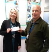 North Wolds Lion Peter Kalesnikovs presenting a cheque for £300 to Kay Kelly, Headteacher of Boynton Primary School