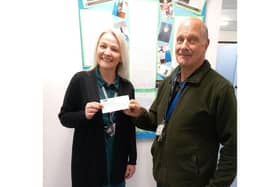 North Wolds Lion Peter Kalesnikovs presenting a cheque for £300 to Kay Kelly, Headteacher of Boynton Primary School