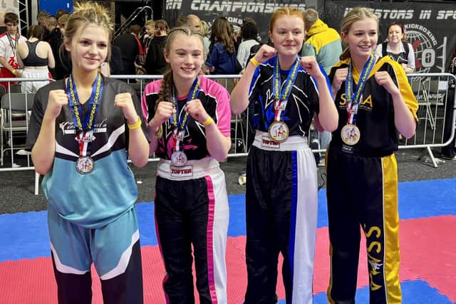 The Tag Team champions, including Typhon stars, second from left, Limerick Goodwin and, second from right, Sarah Dicks.