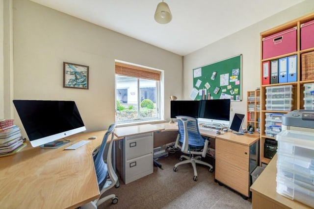 A home office that easily accommodates two desks and office furniture.