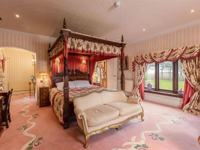 An impressive double bedroom with four poster bed.