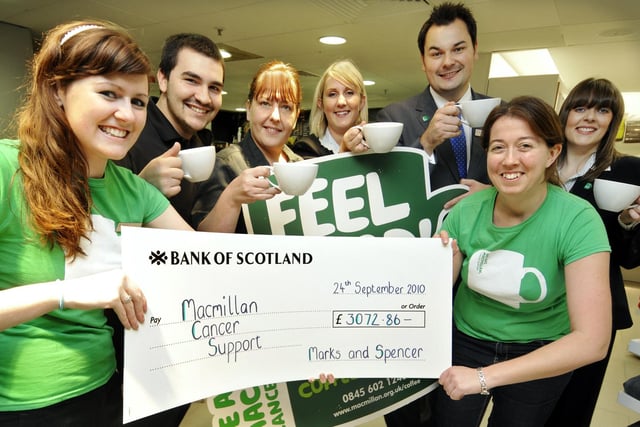Macmillan fundraising manager Sally Millington, front right, is presented with a cheque by Marks and Spencer staff.