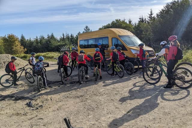 School groups on mountain bikes at the area where the fire started. Image: FMESS