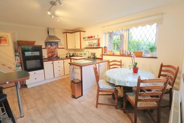 The kitchen with diner has fitted units with a double electric oven, slimline dishwasher and a breakfast bar.