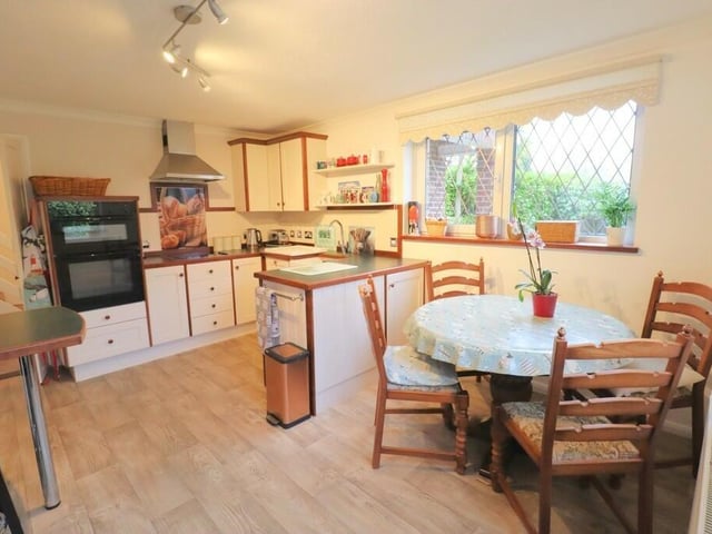 The kitchen with diner has fitted units with a double electric oven, slimline dishwasher and a breakfast bar.