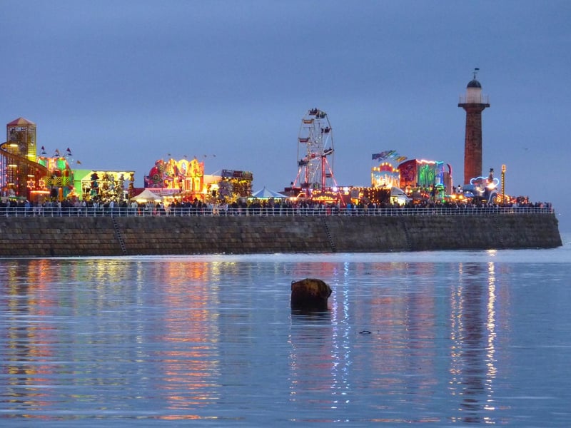 Fairground rides down Whitby west pier light up the night sky at Whitby Regatta 2009.
w093503qq