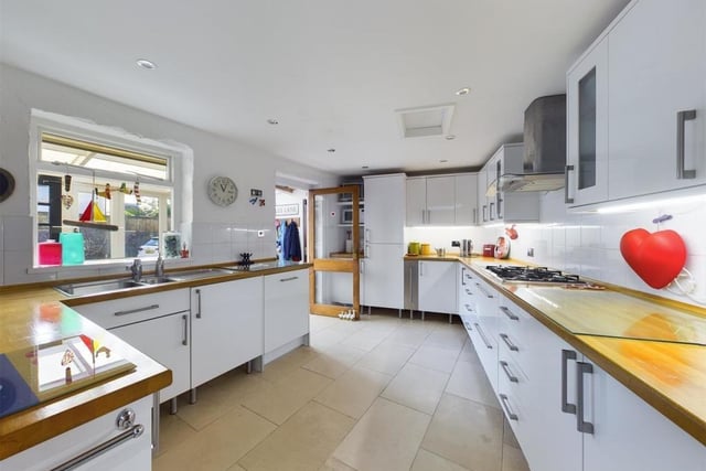 The modern kitchen has fitted units with solid oak worktops, and includes several integrated appliances.