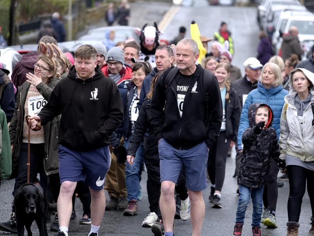 Plenty of people dodged the showers to join the walk