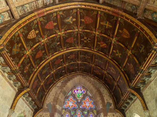 Detailed work on the ceiling of the church, and stained glass windows.