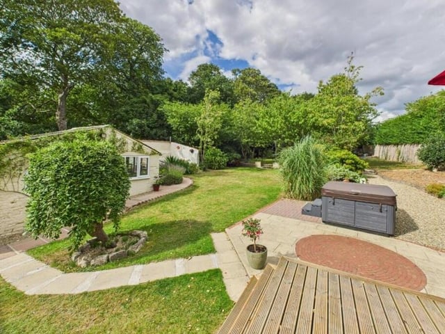 Attractive and extensive gardens have varied seating areas and a summer house.