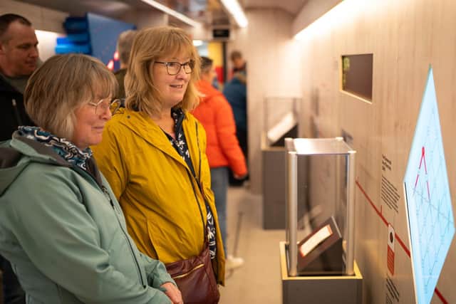 Two visitors enjoy the travelling exhibition train - Credit Railway 200