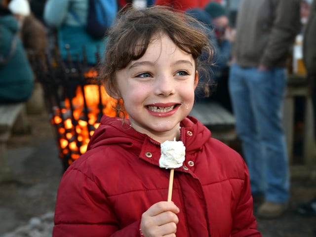 Toasting marshmallows at the festival.