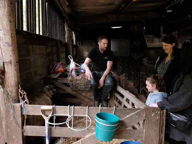 Farmer Ashley talks to the visitors.