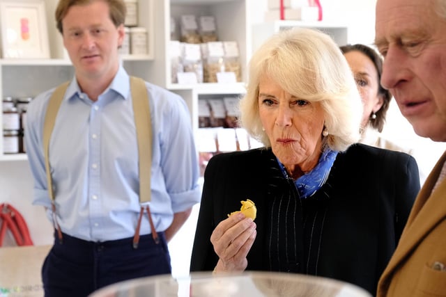 Camilla, the Queen Consort tries some of the delicious food made by the producers Their Majesties met.