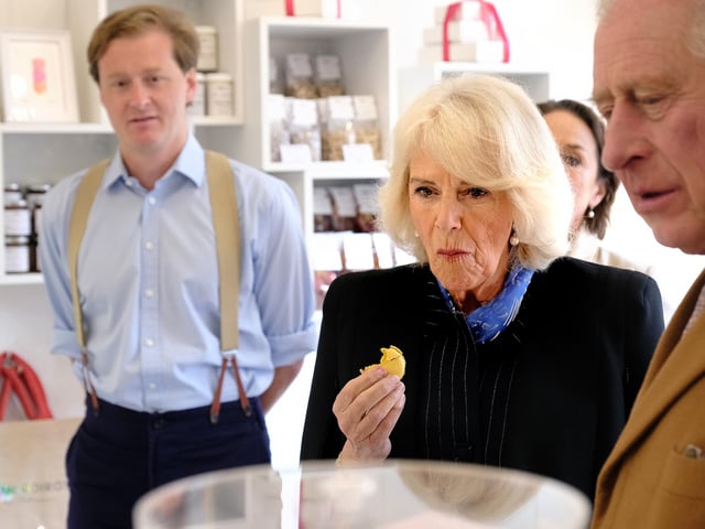 Camilla, the Queen Consort tries some of the delicious food made by the producers Their Majesties met.