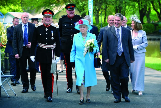 Delight on the faces of the Queen's party as they arrive to huge cheering and flag waving from the crowd of 6,000.
102086z