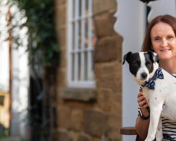 Rachel Spencer and her dog Patch outside Sunnyside Cottage.