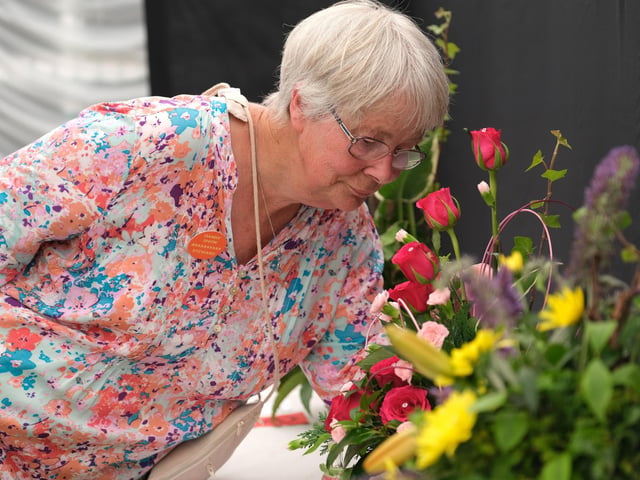 Jane Dingle views the flower display