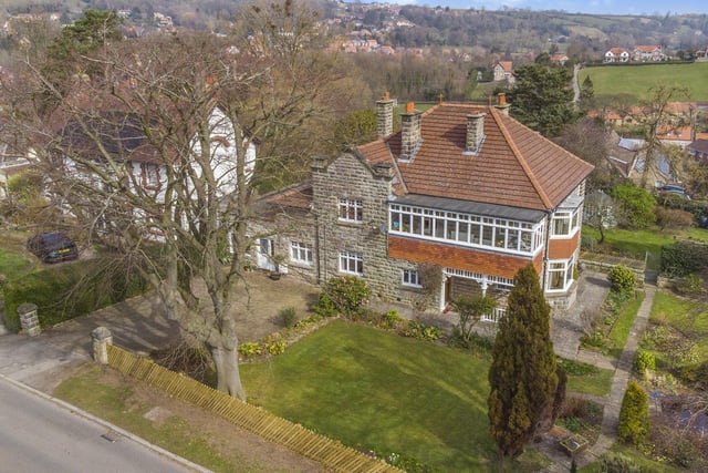 An overview of the front aspect of the detached home, with its front lawned garden.