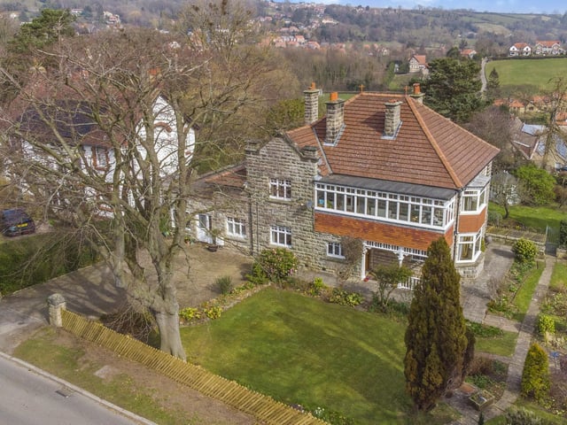 An overview of the front aspect of the detached home, with its front lawned garden.