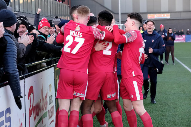 The home supporters join the Scarborough Athletic players in celebrating Lewis Maloney's excellent goal