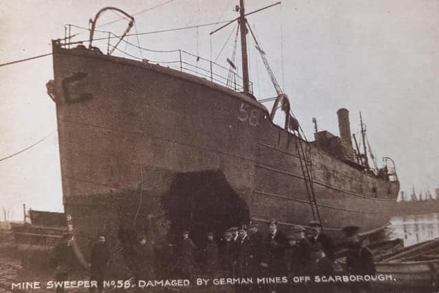 Image of a converted trawler minesweeper damaged by a mine.