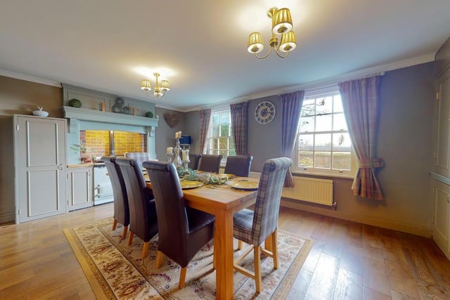 The breakfast room with a feature AGA has two large windows admitting plenty of natural light.