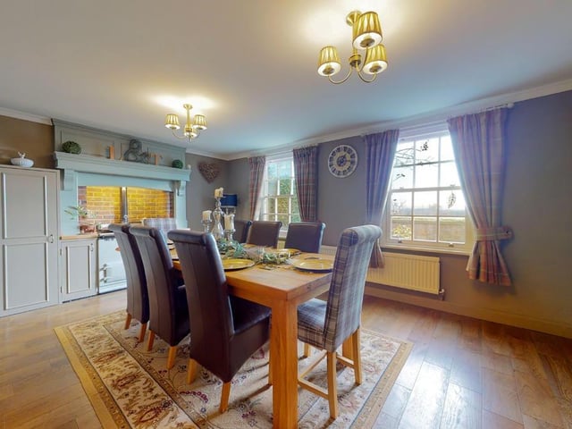 The breakfast room with a feature AGA has two large windows admitting plenty of natural light.