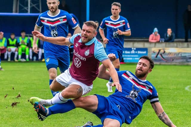 Whitby's Dan Rowe tackles ex-Blue Paul Blackett.