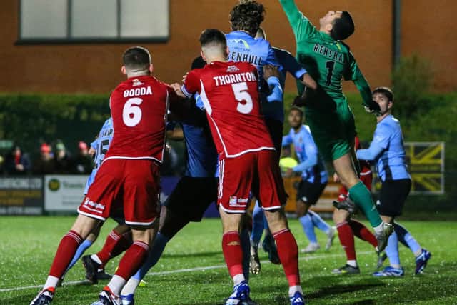 Southport keeper Chris Renshaw is at full stretch to claim the ball.