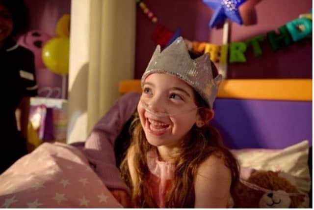 A young girl celebrates her birthday in a hospice.