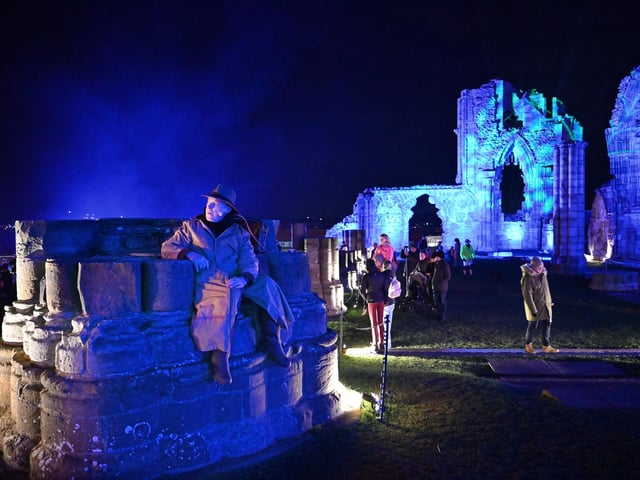 Visitors exploring the abbey after dark